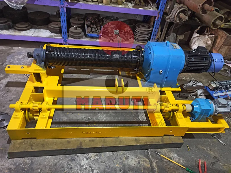 MARUTI winch assembly with grooved rope drum, gearbox and motor on a yellow frame in the Sahjanand workshop